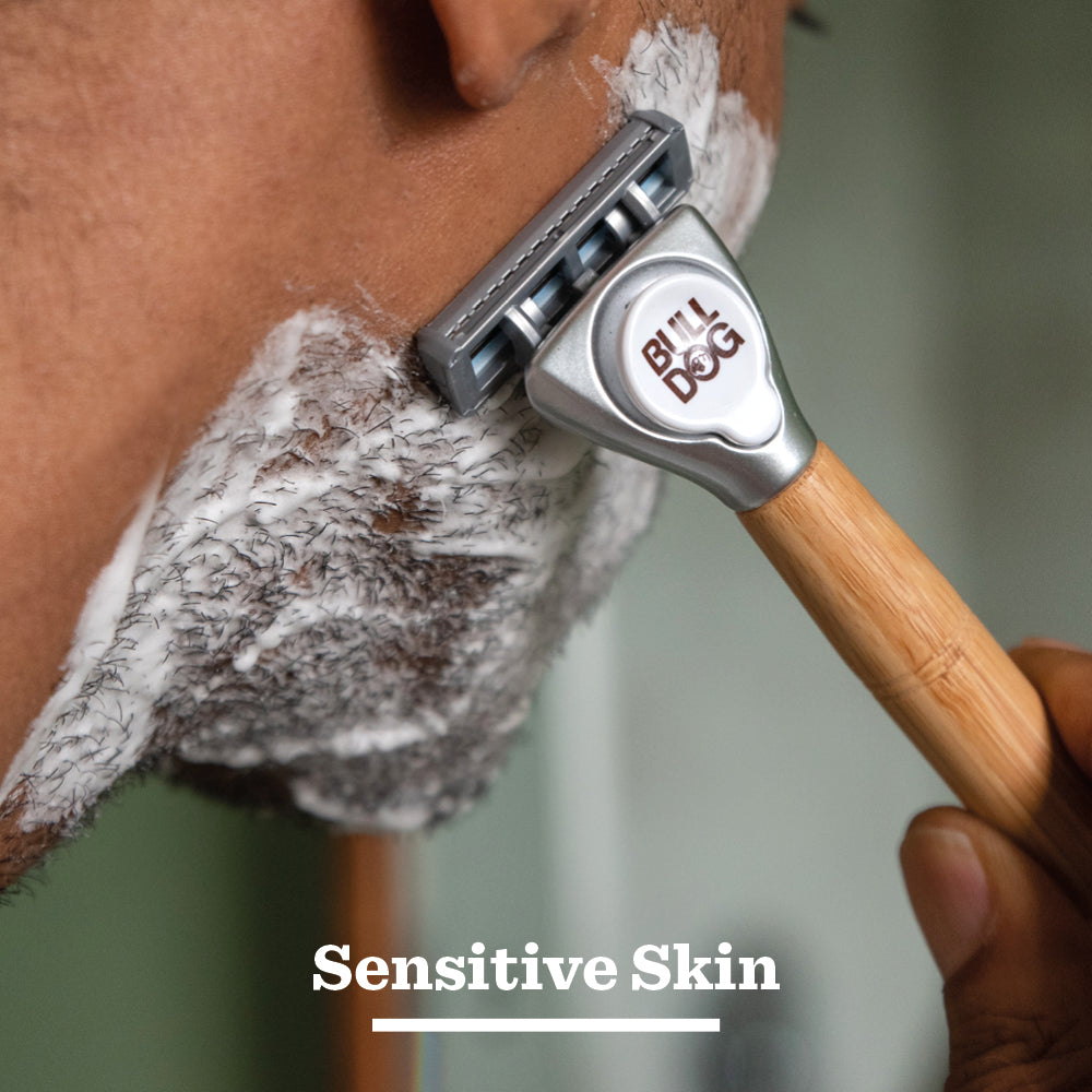 A close-up of a person shaving with a Bulldog razor, applying Sensitive Foaming Shave Gel. The words “Sensitive Skin” appear at the bottom of the image.