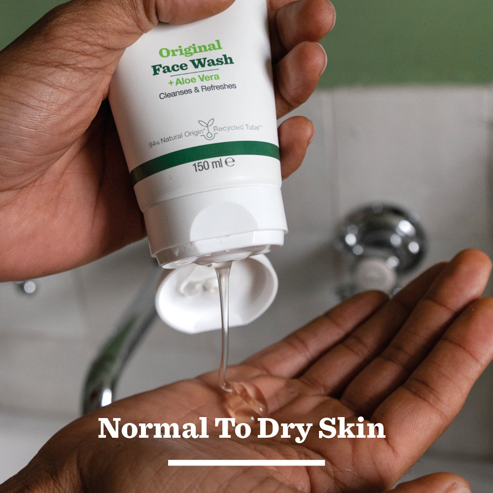 A person sprays the Original Spray Deodorant Bundle from a white can onto their underarm. The product label is visible, and text at the bottom reads for all-day freshness. A sink appears in the background, emphasizing a daily grooming routine.